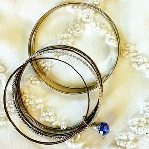 Silver bangle set with iridescent blue accent